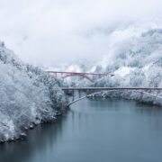 Red bridge over shokawa gorge river in toyama prefecture, japan